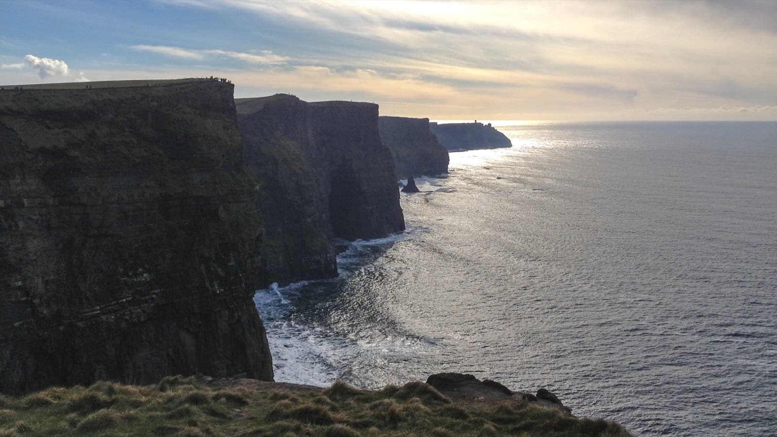 The Cliffs of Moher rising steeply from the Atlantic on Ireland's west coast under an overcast sky