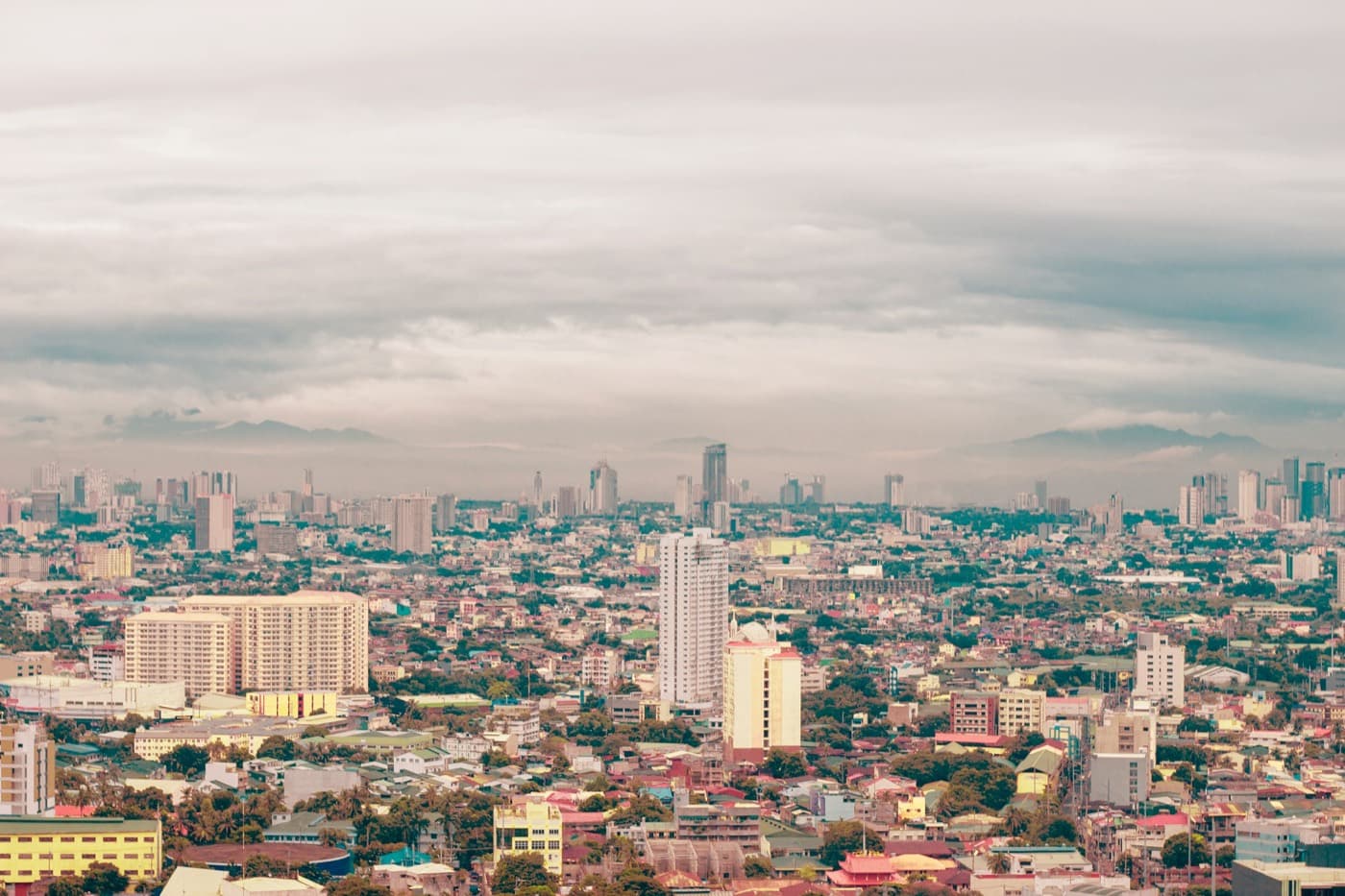 The Manila skyline and the Ermita district under an overcast sky.